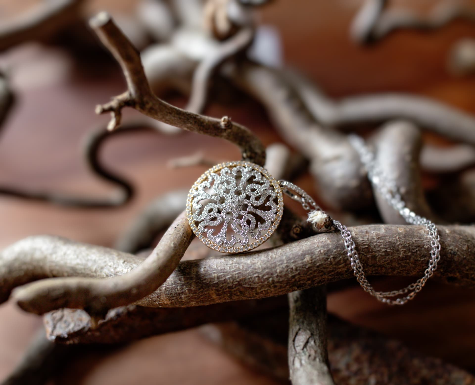Round filigree diamond pendant on a chain
