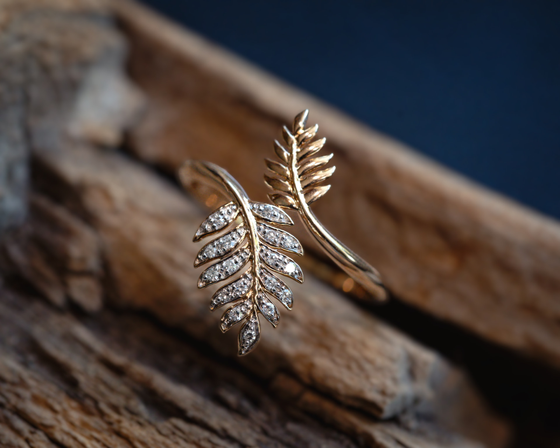 Gold leaf-style ring set with pavé diamonds