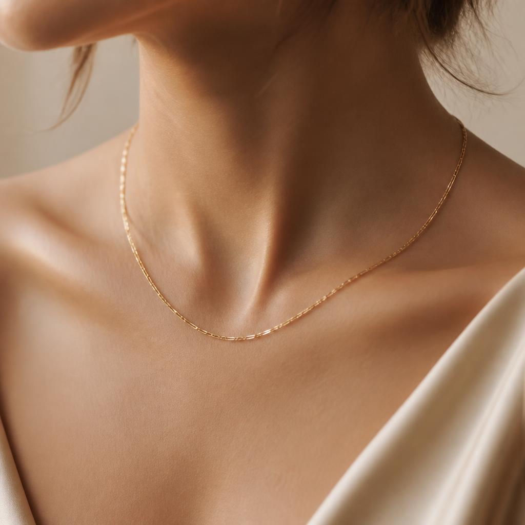 Delicate permanent gold chain necklace on a collarbone